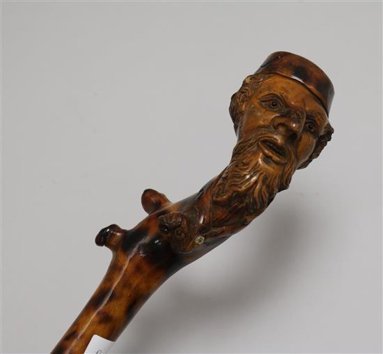 A carved wooden walking stick, with figural handle height 89cm